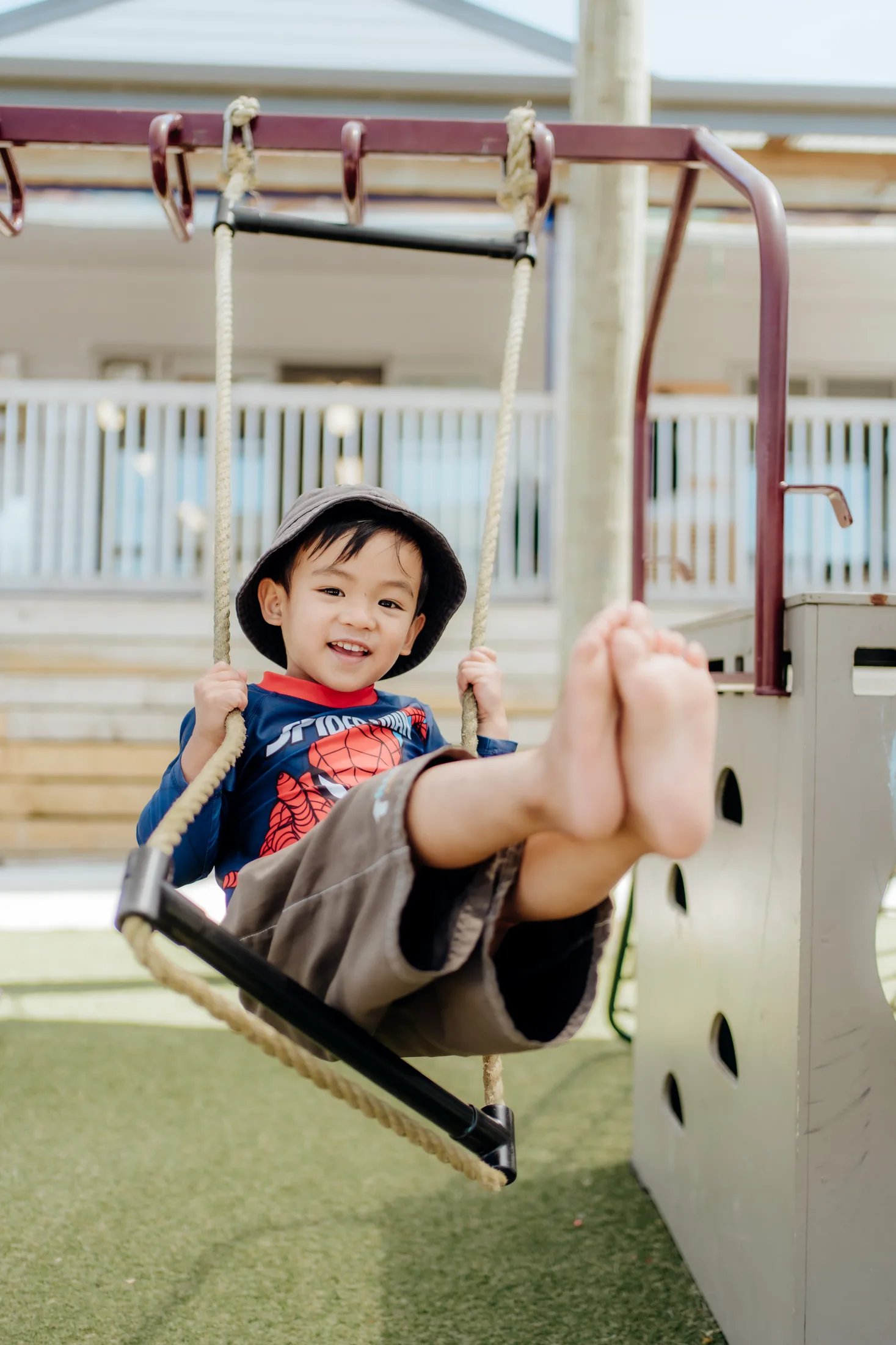 A child enjoying the outdoor swing